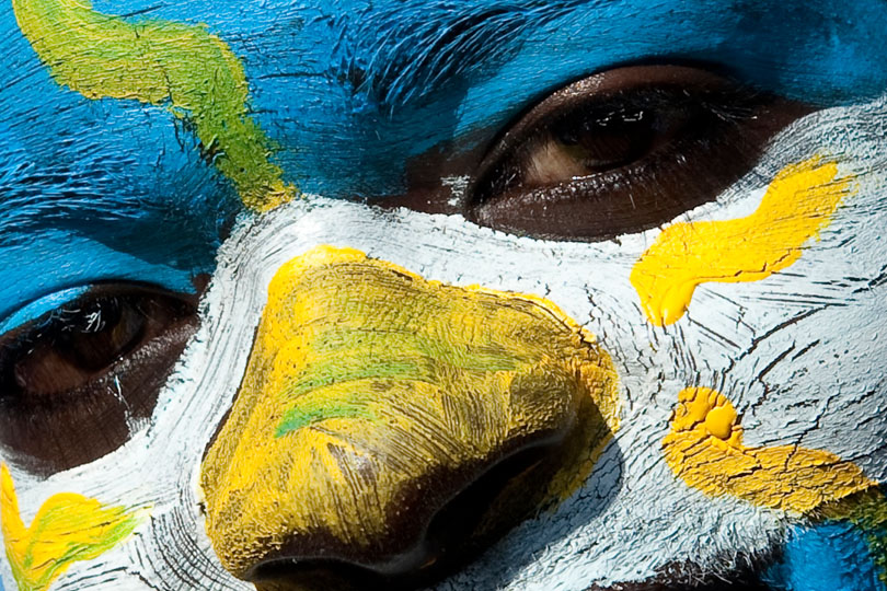 African soccer fan with Argentina face make-up