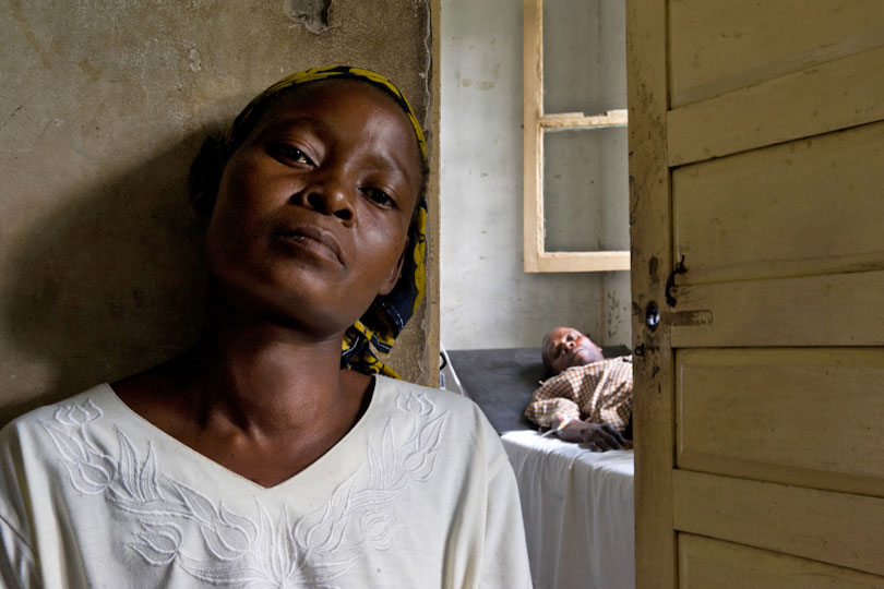 Woman waiting for her sick husband to have a medical check &lt;p&gt;in a dispensary, Quelimane, Mozambique
